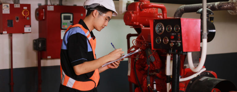 Young engineer check fire suppression system at conrol room of factoryYoung engineer check fire suppression system in control room of factory , daily check job of maintenance technician